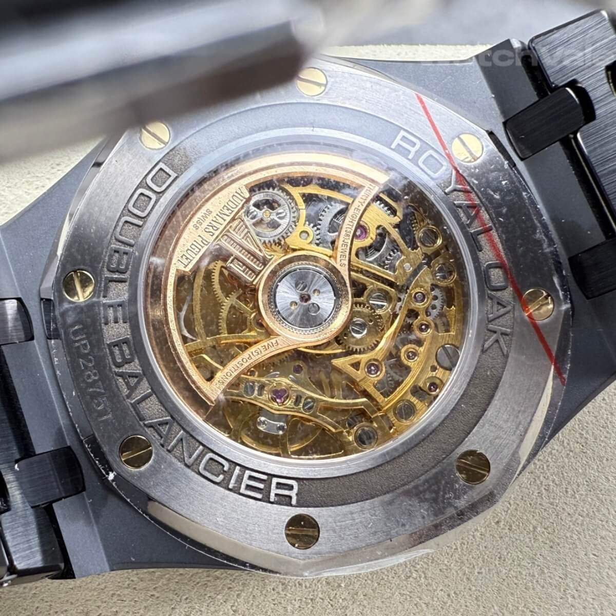 Skeleton dial replica watch with black ceramic bridges and mainplate close-up