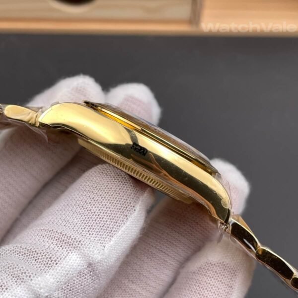 Green dial replica watch with yellow gold hour markers close-up