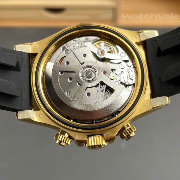 Black dial replica watch with yellow gold hour markers close-up