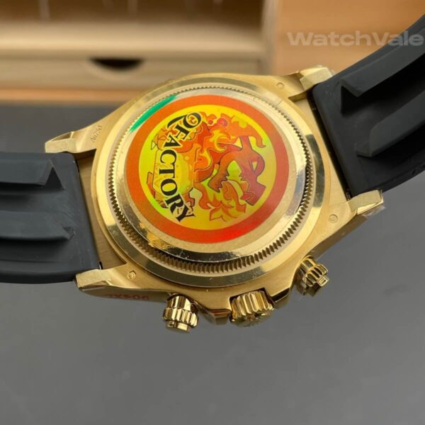 Black champagne dial replica watch with yellow gold hour markers close-up